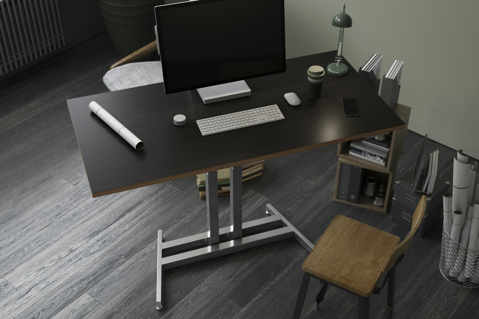 Dark wood desk with a single iMac, keyboard, and small architectural model, on a gray plank floor
